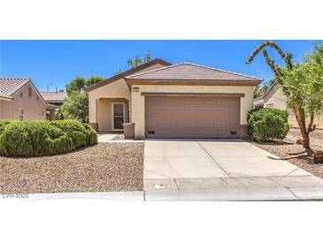 Charming single-story home featuring a neutral facade, desert landscaping, and an attached two-car garage at 2535 Leighton Ave, Henderson, NV 89052