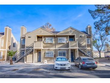 Inviting home exterior with dual staircases, updated siding, and well-maintained landscaping offers curb appeal at 2696 Jennydiane Dr, Las Vegas, NV 89121