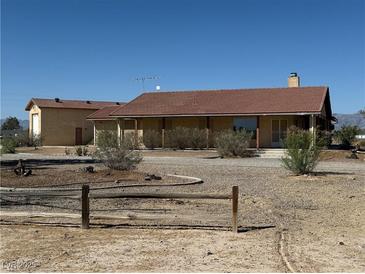 Charming ranch-style home with desert landscaping and spacious front yard at 3090 N Woodchips Rd, Pahrump, NV 89060