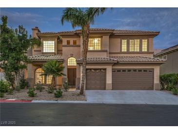 Elegant two-story home featuring a three-car garage, desert landscaping, and a stately entrance at 4664 Stuttgart St, Las Vegas, NV 89147