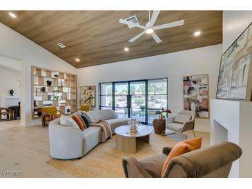 Bright living room features vaulted ceilings, recessed lighting, and stylish furniture at 9520 Sundial Dr, Las Vegas, NV 89134