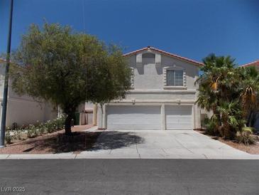 Two-story home with a two-car garage and desert landscaping at 1018 Sun Poppy Ave, Las Vegas, NV 89123