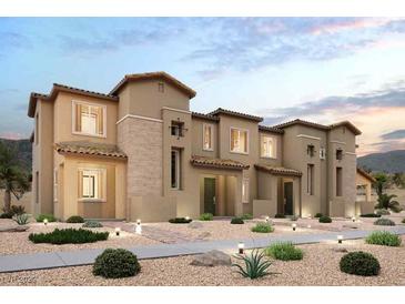 Beautiful multi-level townhouse with a neutral stucco facade, stone accents, desert landscaping, and a tiled roof at 188 Wewatta Ave, Henderson, NV 89011