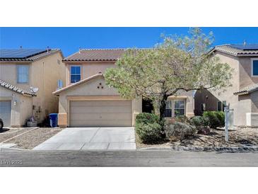 Two-story tan home featuring a two-car garage and desert landscaping at 262 Calvino Ave, Las Vegas, NV 89183