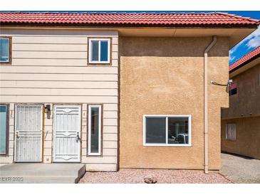 Charming exterior of a two-story home featuring a red tile roof and neutral-toned siding at 2915 Cedar Ave # 12C, Las Vegas, NV 89101