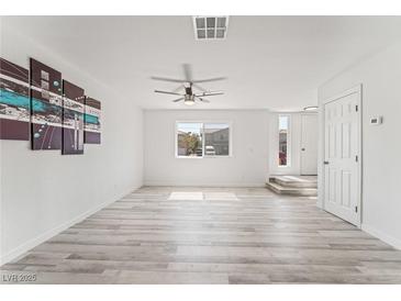 Bright living room featuring wood-style flooring, a ceiling fan, and white walls at 2915 Cedar Ave # 12C, Las Vegas, NV 89101