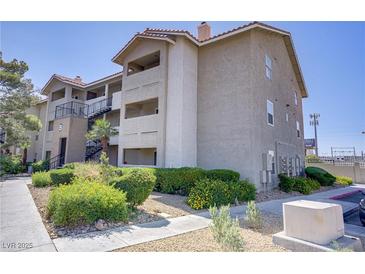 Condominium exterior featuring a well-maintained building, landscaping, and exterior stairs at 4200 S Valley View Blvd # 1120, Las Vegas, NV 89103