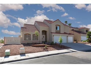 Attractive two-story home with a red tile roof, low maintenance desert landscaping, and a two-car garage at 426 Lost Trail Dr, Henderson, NV 89014
