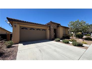 Beautiful single-story home with a two-car garage, stone accents, and well-maintained landscaping at 4732 S Adriano Way, Pahrump, NV 89061