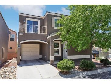 Charming two-story home with a quaint balcony, attached garage and well-manicured front yard at 6313 Pangea Ave, Las Vegas, NV 89139