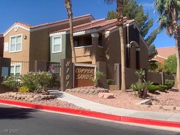 Condo exterior with mature landscaping and desert themed rock covering at 8101 W Flamingo Rd # 1102, Las Vegas, NV 89147