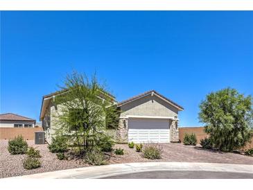 Charming single-story home featuring a two-car garage and desert landscaping at 879 Klamath Springs St, Henderson, NV 89011