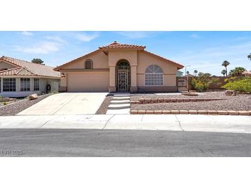 Charming single-story home with a well-manicured front yard and a covered entryway at 1613 Glenrosa Dr, North Las Vegas, NV 89031