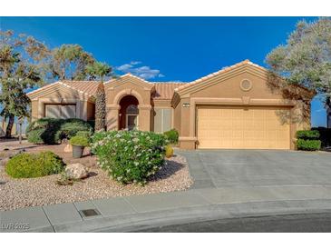 Charming single-story home featuring a well-manicured front yard with desert landscaping and an attached two-car garage at 1904 Hot Oak Ridge St, Las Vegas, NV 89134