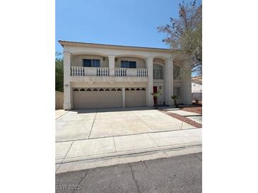 Two-story home with three-car garage, balcony, and well-maintained front yard at 1941 Golden Trumpet Ave, Las Vegas, NV 89123