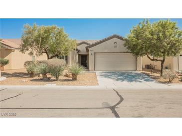Charming single-story home with desert landscaping, neutral paint, and a two-car garage at 3405 Kingbird Dr, North Las Vegas, NV 89084