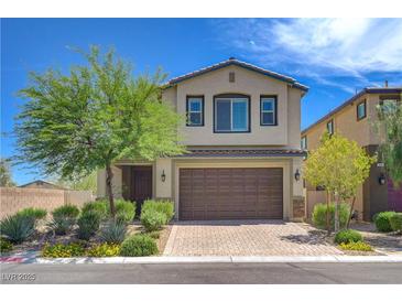 Charming two-story home features a landscaped front yard and a two-car garage with brick paved driveway at 3949 Amanda Bay Ave, North Las Vegas, NV 89081