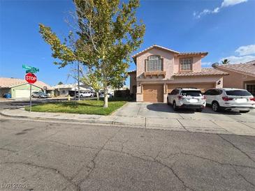 Charming two-story home with a well-manicured lawn and an attached two-car garage at 6363 Berry Patch Way, Las Vegas, NV 89142