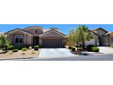 Charming single-story home with a well-manicured front yard and a two-car garage at 7395 Howell Mill Ct, Las Vegas, NV 89113