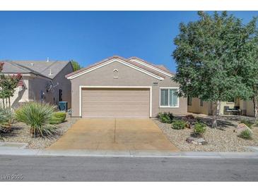Charming single-story home with a two-car garage, desert landscaping, and a well-maintained front yard at 7916 Lyrebird Dr, North Las Vegas, NV 89084