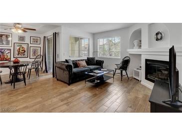 Inviting living room featuring a fireplace, comfortable seating, and ample natural light from the window at 7950 W Flamingo Rd # 1042, Las Vegas, NV 89147