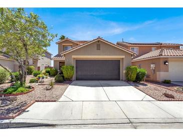 Charming two-story home with a well-maintained front yard and a spacious two-car garage at 1228 Swanbrooke Dr, Las Vegas, NV 89144