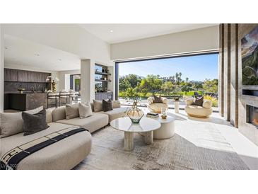 Bright living room featuring modern furnishings and expansive views of the golf course at 1429 Iron Hills Ln, Las Vegas, NV 89134