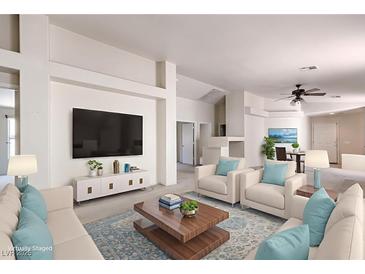 Bright living room featuring modern furniture, a large screen television, and neutral decor at 3640 Shanagolden St, Las Vegas, NV 89129