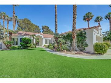 Charming single-story home featuring a tile roof, manicured lawn, and mature palm trees in a desirable neighborhood at 5224 Painted Lakes Way, Las Vegas, NV 89149