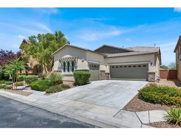 Charming single-story home with a well-manicured front yard and a three-car garage at 5908 Big Horn View St, North Las Vegas, NV 89031