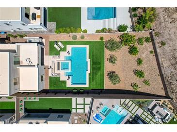 Stunning aerial view of backyard oasis with pool, spa, and modern outdoor furniture at 734 Glowing Horizon St, Henderson, NV 89052