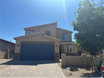 Two-story home featuring a paver driveway, a two-car garage and a modern design at 7636 Bandon Cliffs St, North Las Vegas, NV 89084