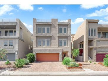 Contemporary three-story home featuring a garage and low-maintenance landscaping at 8072 Haywood Estate, Las Vegas, NV 89113