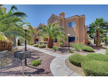 Condo exterior with palm trees, landscaping, and a walkway leading to the building entrance at 900 Heavenly Hills Ct # 114, Las Vegas, NV 89145