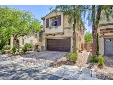 Two-story home with a brick-paved driveway and attached two-car garage at 9814 Gifthouse St, Las Vegas, NV 89178