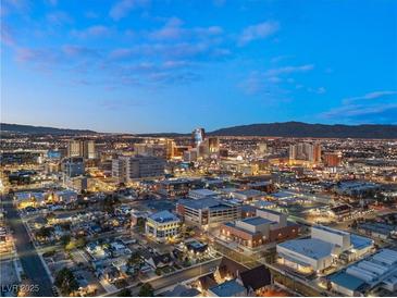 Expansive city view at dusk showing bright lights and mountain range in the background at , Las Vegas, NV 89101