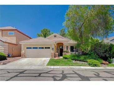 Charming single-story home with a well-manicured front yard and a two-car garage in a quiet neighborhood at 10198 Timber Willow Ave, Las Vegas, NV 89135