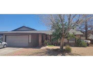 Charming single-story home featuring a two-car garage, mature tree, and desert landscaping at 1886 Ludington Ave, Las Vegas, NV 89156