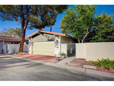 Charming single-story home featuring a two-car garage, gated entry, and brick-paved driveway at 1905 Plaza Del Padre, Las Vegas, NV 89102