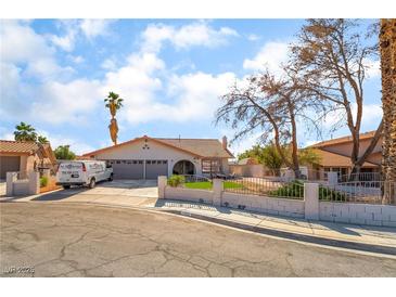 Charming single-story home showcasing a well-maintained front yard, two car garage, and inviting curb appeal at 327 Fuente Dr, Henderson, NV 89014
