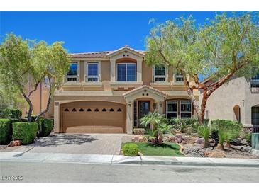 Charming two-story home featuring a well-manicured lawn, mature trees, and a two-car garage at 6564 Baroque Ave, Las Vegas, NV 89139