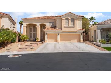 Charming two-story home with a tile roof and attached three-car garage, set in a desert landscape at 8605 Trianon Ln, Las Vegas, NV 89145