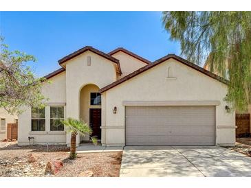 Charming single-story home featuring a two-car garage and desert landscaping at 3609 Blue Pimpernel Ave, North Las Vegas, NV 89081