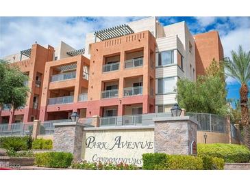 Stylish condominium building featuring balconies and modern architectural design in a landscaped setting at 63 E Agate Ave # 202, Las Vegas, NV 89123