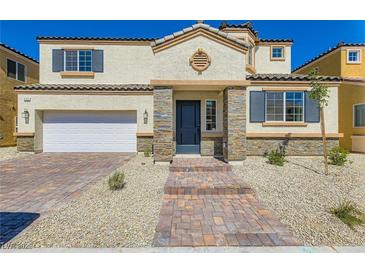 Charming two-story home featuring a stone entryway, two-car garage, and a well-maintained front yard with desert landscaping at 9722 Rocket Grove Ct, Las Vegas, NV 89178