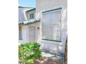 Charming townhouse with decorative tile accents and secure front entry at 2471 Old Forge Ln # 105, Las Vegas, NV 89121