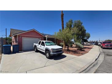 Modest single-story home featuring a driveway, front yard with sparse landscaping, and an attached garage at 2965 Palma Vista Cir, Las Vegas, NV 89169