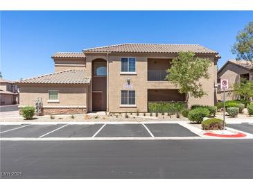 Inviting exterior view of a two-story home with manicured landscaping and convenient parking at 6635 Caporetto Ln # 204, North Las Vegas, NV 89084