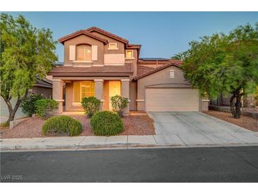 Charming two-story home featuring a well-manicured front yard, attached garage, and inviting curb appeal at 1011 Pecos River Ave, Henderson, NV 89002
