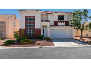 Two-story home featuring a red tiled roof, brick accents, and a two-car garage at 10952 Porto Foxi St, Las Vegas, NV 89141